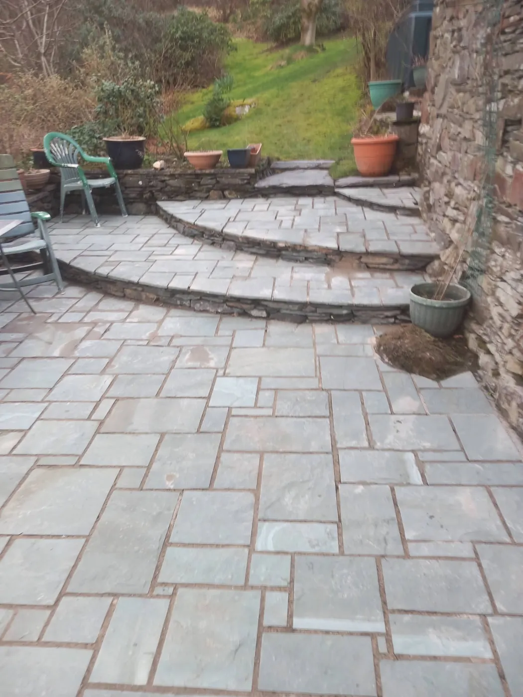 Finished slate patio with curved stone steps in a Lake District garden